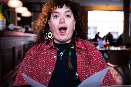 Young woman astonished about the menu 
