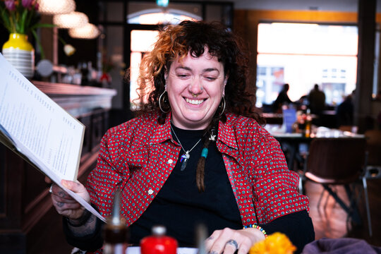 Young woman astonished about the menu 