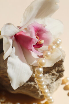 a pearl necklace gracefully encircling a delicate orchid flower