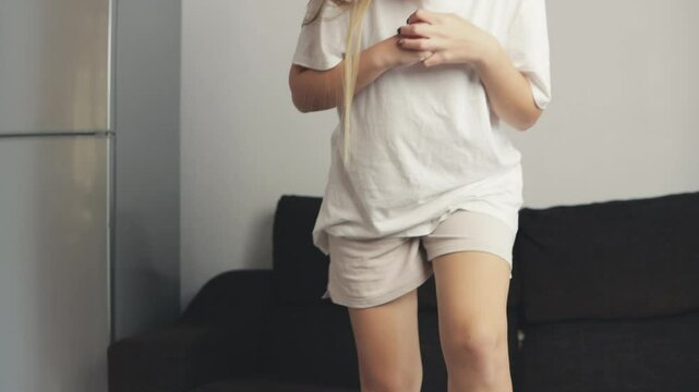 Teenager Girl preparing for a workout on a mini stepper at home. Dressed in comfortable attire, she is set to begin her exercise routine