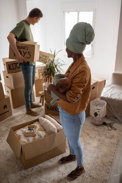 Multiracial family unpacking in new home