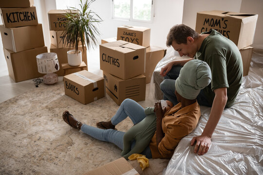 Happy couple feeding baby while moving in