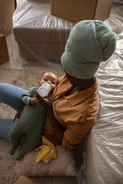 Mom feeding baby at new home