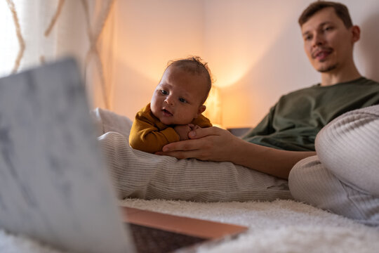 Newborn watching interesting cartoon