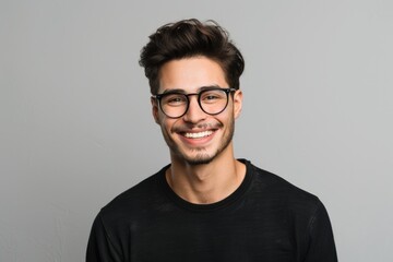 Obraz premium Stylish man in glasses with bright smile on neutral background