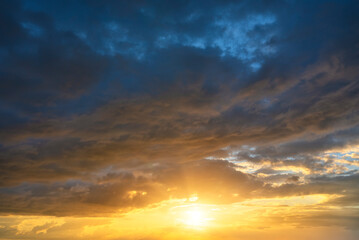 Obraz premium Real sky texture background with bright sun at sunset. Dramatic red and orange clouds.