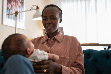 Mom playing with newborn 