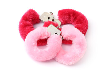 Pink fluffy handcuffs isolated on white. Sex toy
