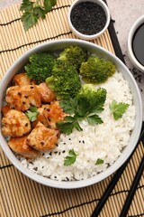 Tasty rice with broccoli and chicken served on table, top view