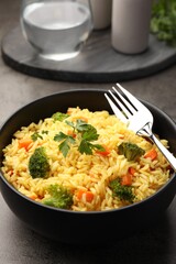 Tasty rice with vegetables on grey table, closeup