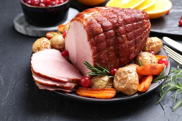 Christmas food. Tasty baked ham served on black table, closeup