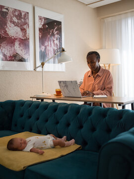 Mother working while baby sleeping
