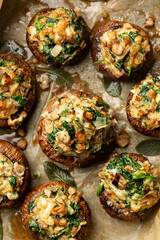 Top view and closeup of  just baked Cremini Mushrooms stuffed with roasted mushrooms legs, with onion, spinach, bread crumbs and goat cheese.