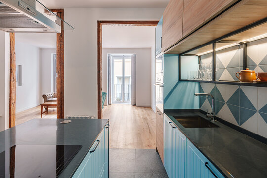 Modern kitchen with blue cabinets and a tiled backsplash