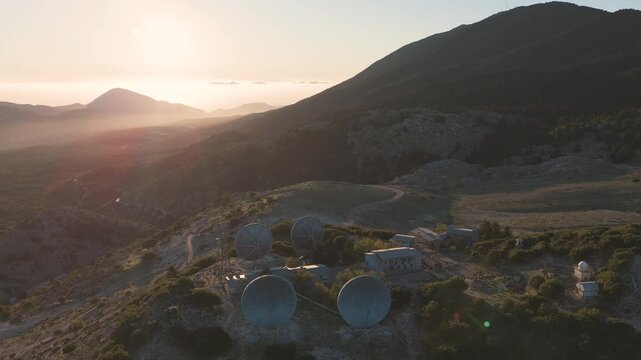 Satellite dishes on mountain top at sunset