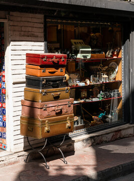 Stack of Vintage Suitcases Outside Antique Shop

