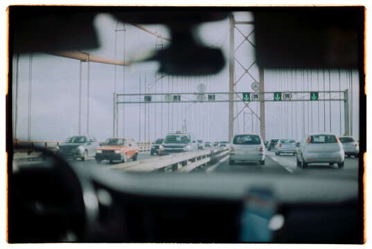 View from the car on the bridge on 25 de Abril Bridge, Lisbon, on film