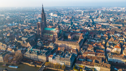 Strasbourg, the capital of Christmas, sparkles during Advent, with its stunning decorations and festive ambiance. This aerial view features the majestic Strasbourg Cathedral, La Petite France 