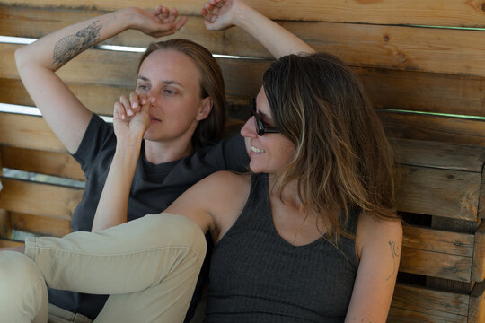 Two friends relax and enjoy a moment together in a cozy setting