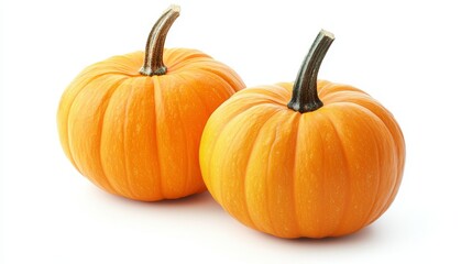 Obraz premium Two small orange pumpkins on a white background