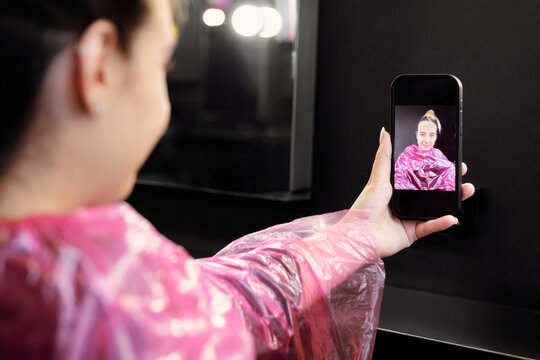 Capturing Hair Salon Moments with Selfie in Pink Cape