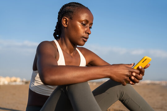 Woman tracking activity data during break from exercise