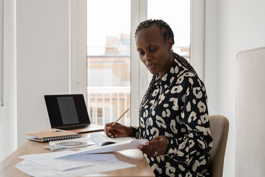 Woman reviewing documents while preparing for the flight