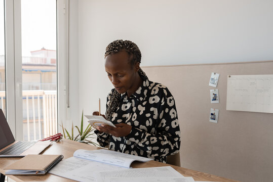 Focused female pilot student planning flight