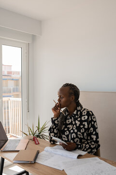Woman thinking while studying