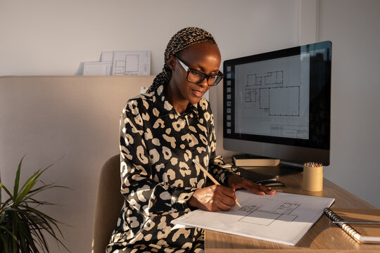  Smiling architect designing building