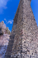 Scenic view of railway viaduct named Schmittentobel at Albula Valley with blue sky background in...