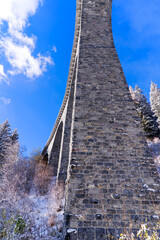 Scenic view of railway viaduct named Schmittentobel at Albula Valley with blue sky background in...