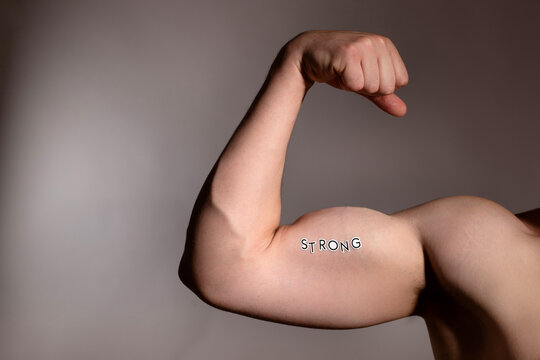 Arm flexing with strong text emphasizes health and fitness