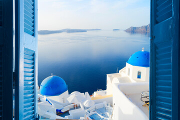 white church belfry, brigh blue domes and volcano caldera with sea landscape, beautiful details of Santorini island, Greece