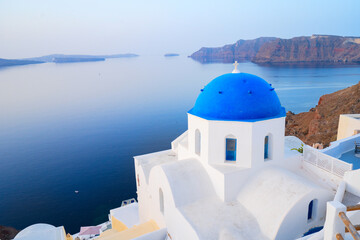 traditional greek village Oia of Santorini, with blue domes of churches and village roofs, Greece