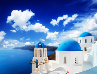 traditional greek village Oia of Santorini, with blue domes against sea and caldera, Greece