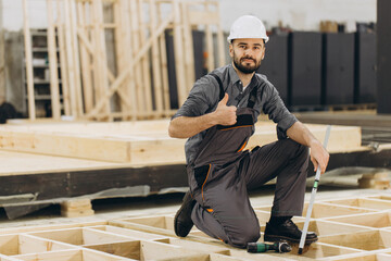 Construction worker gesturing thumbs up in modular building industry