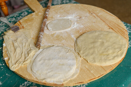 Rolled dough layer with roller pin on the table