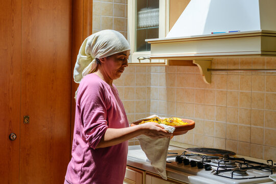 Moroccan woman brings to the table the traditional Tajine