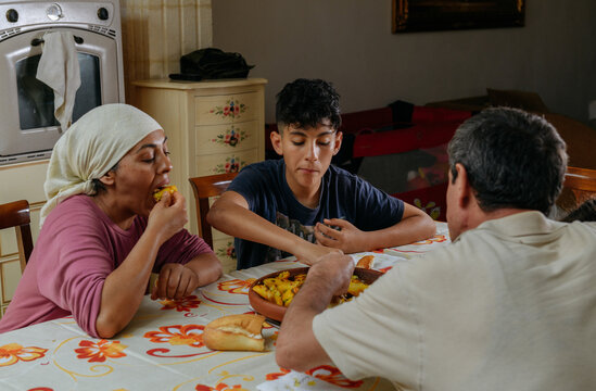 Multicultural family eating a moroccan dish Tajine