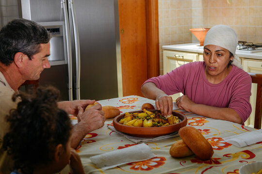 Multicultural family eating a moroccan dish Tajine