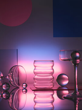 crystal cups on colored background