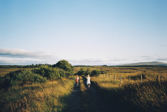 Two girls walking in the rural countryside