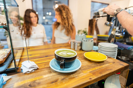 Matcha latte art being prepared for customers in coffee shop - Powered by Adobe