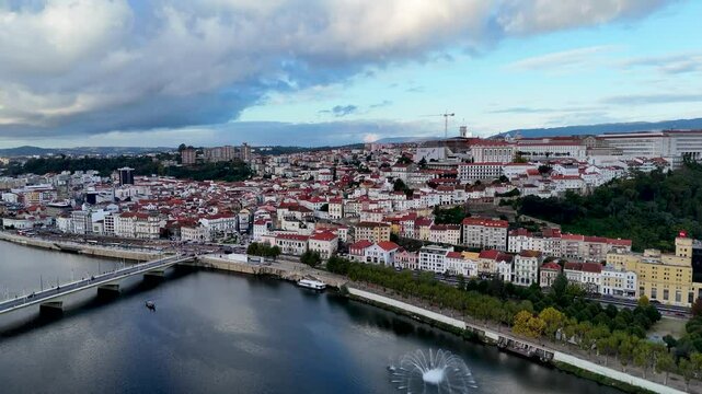 4K drone video footage of Coimbra city old town on the hill. Panoramic aerial cityscape of Coimbra university and Mondego River, Portugal