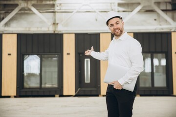 Architect showing modern modular house under construction