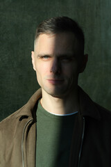 Mysterious portrait of a young man in shadow and sunlight at dusk