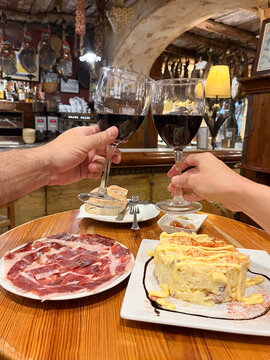 Anonymous couple toasting in restaurant