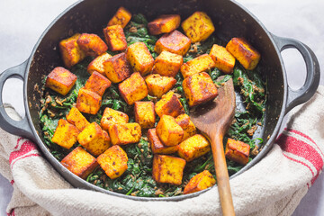 Saag paneer. Fried paneer cheese with turmeric, onion, garlic and spinach 