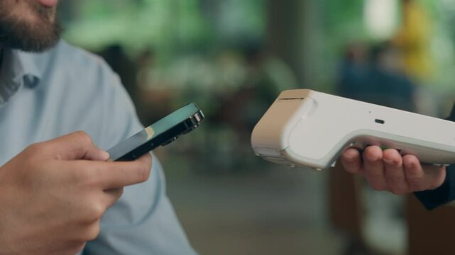 Contactless payment visitor customer business client buyer cafe man guy male businessman pay phone NFC smartphone purchase online bank credit card scan wifi technology terminal waiter serving cashless